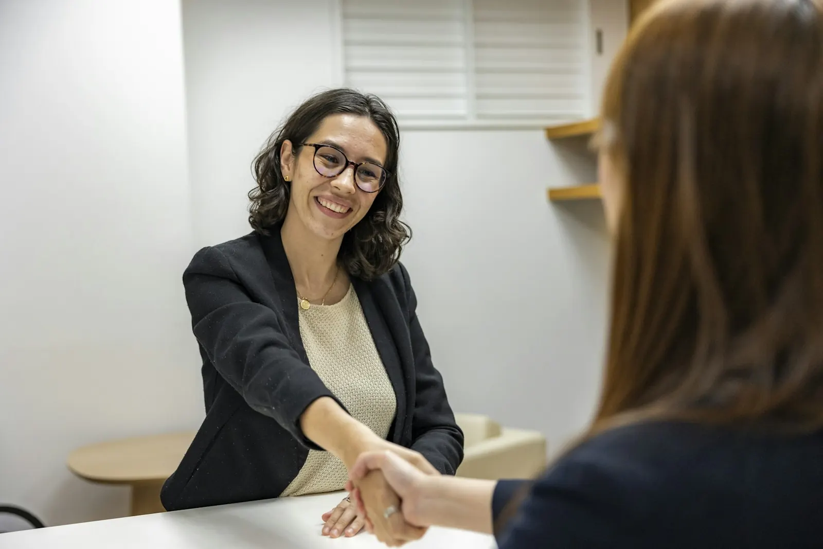 Claim professional shaking hands with a client
