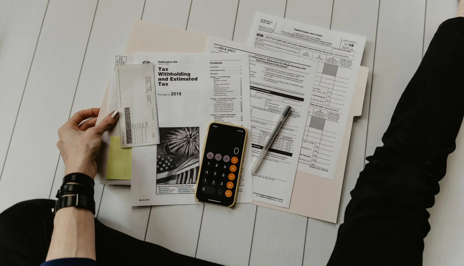 Reviewing estimate paperwork with a calculator