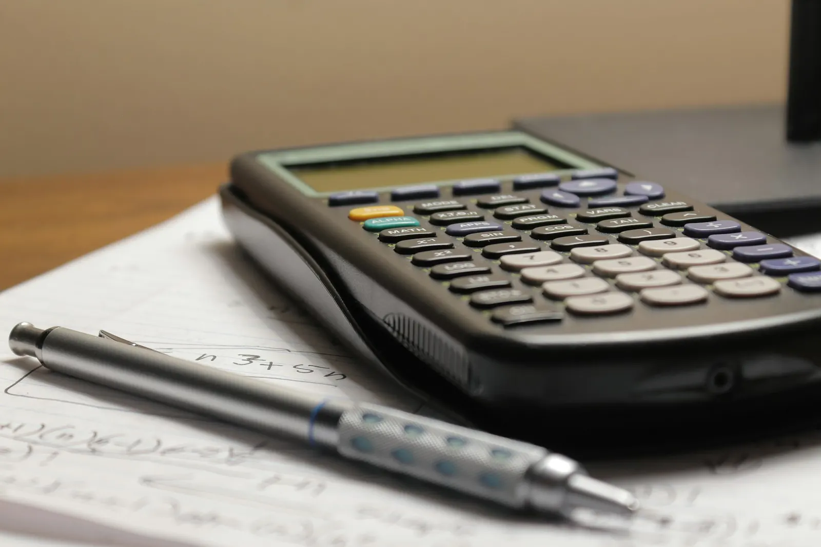 Calculator and pencil on notepaper
